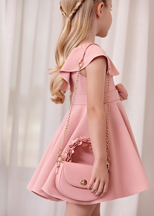 Girl holding floral handle bag in blush.